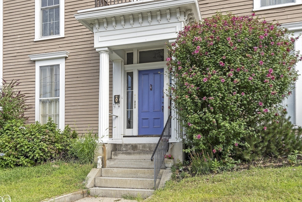 214 3rd Street, Unit A Lowell, MA 01850 - Photo 26 of 32 a front view of a house with plants