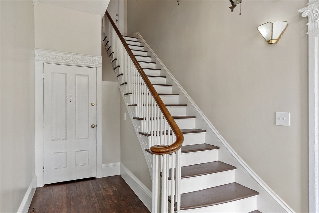 214 3rd Street, Unit A Lowell, MA 01850 - Photo 29 of 32 a view of a hallway with wooden floor and staircase