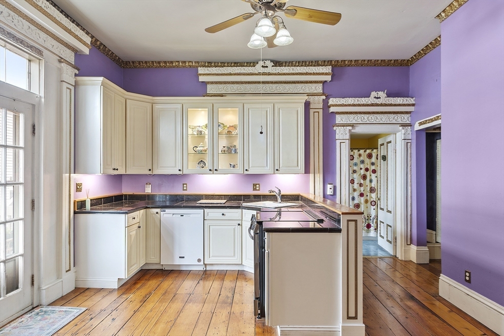 214 3rd Street, Unit A Lowell, MA 01850 - Photo 6 of 32 a kitchen with stainless steel appliances granite countertop a stove and cabinets