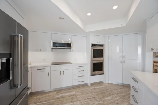 a kitchen with stainless steel appliances cabinets and a counter top space