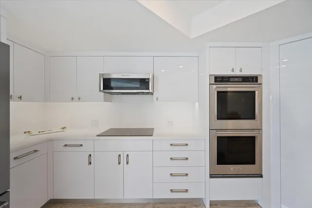 a kitchen with cabinets stainless steel appliances and counter space