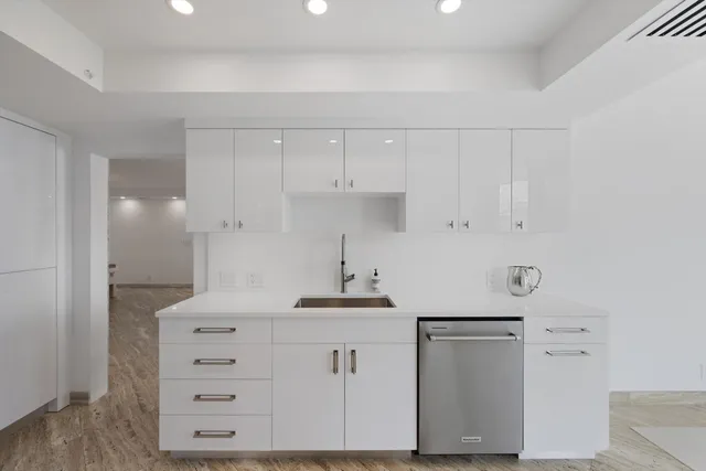 a kitchen with cabinets appliances and a counter space
