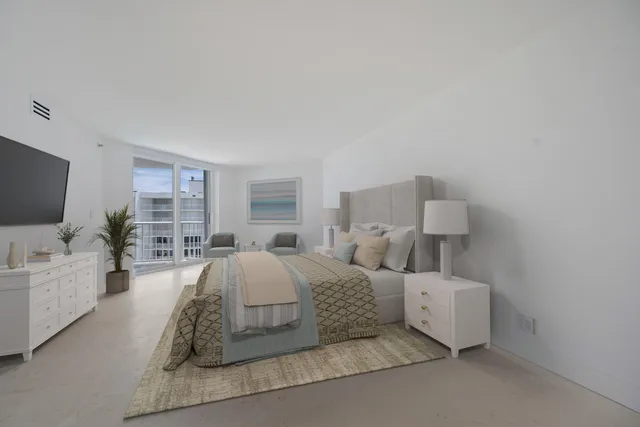 a spacious bedroom with a bed and a flat screen tv