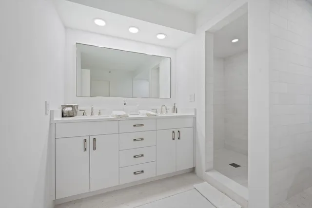 a bathroom with a granite countertop sink mirror and double