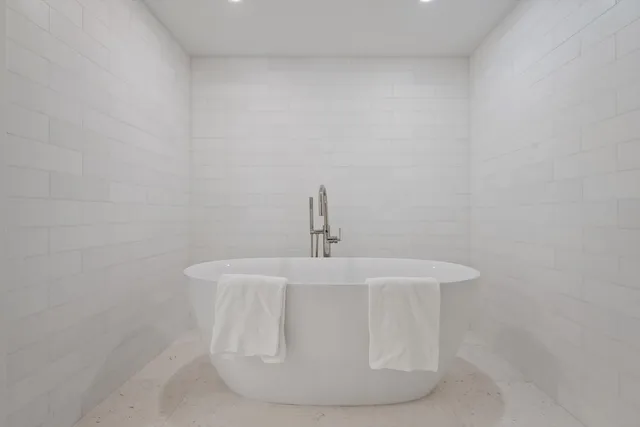 a white bath tub sitting in a white tub