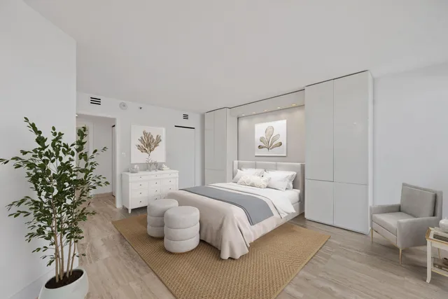 a bedroom with bed and a potted plant