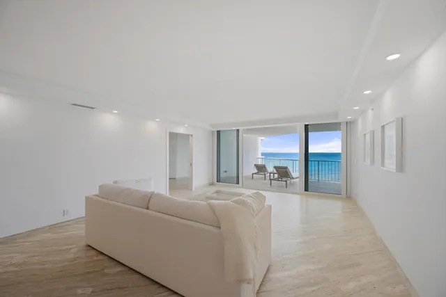 a living room with furniture and large windows