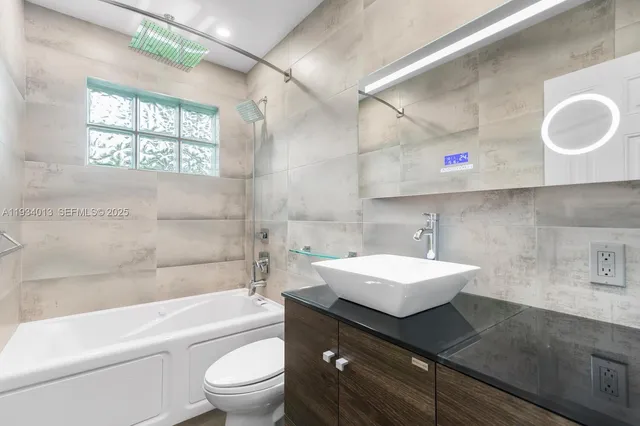 a bathroom with a sink a toilet and a bathtub