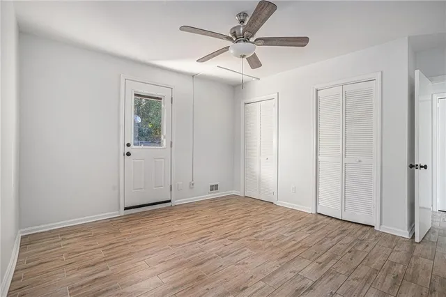 a view of empty room with wooden floor