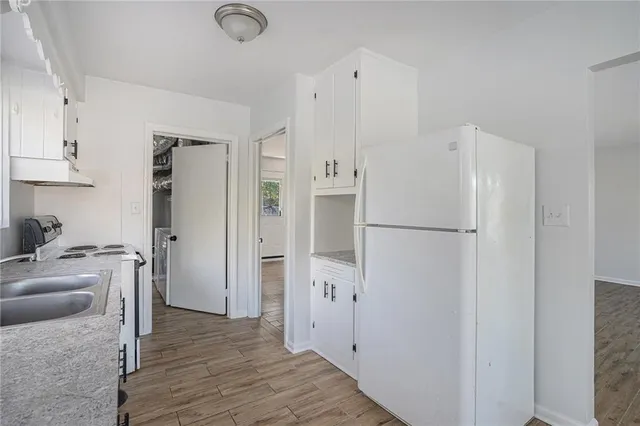 a kitchen with stainless steel appliances a refrigerator and a cabinets