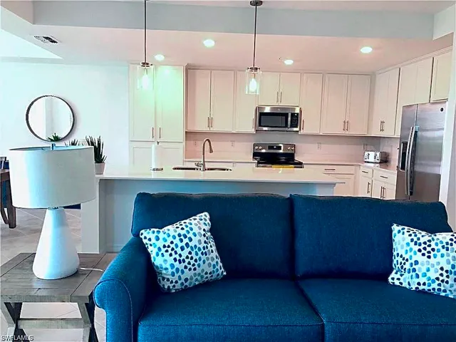 a kitchen with cabinets a sink and a chandelier