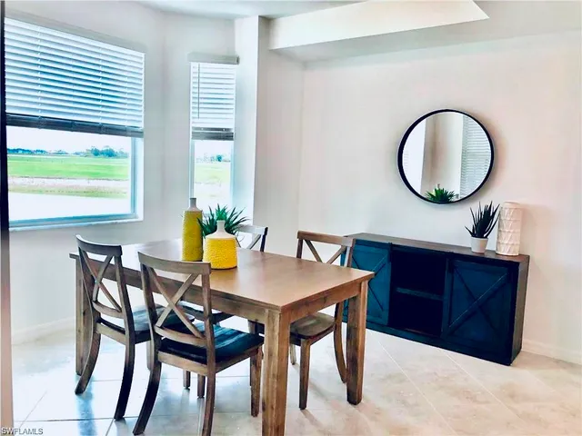 a view of a dining room with furniture and a window
