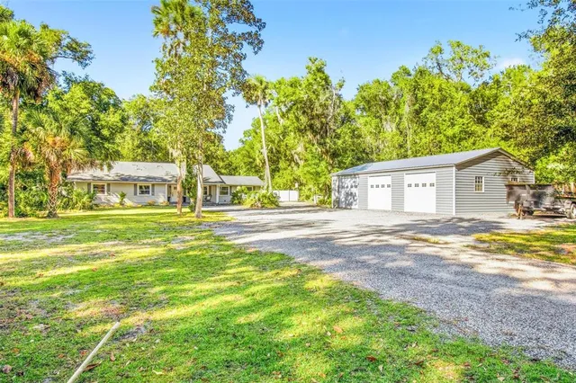 a dining room with furniture a chandelier and wooden floor