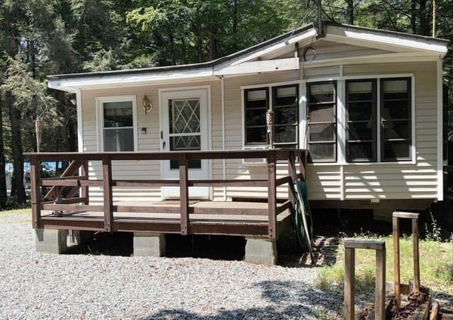 759 North Main Road, Unit V8J Otis, MA 01253 - Photo 2 of 21 a front view of a house with parking space