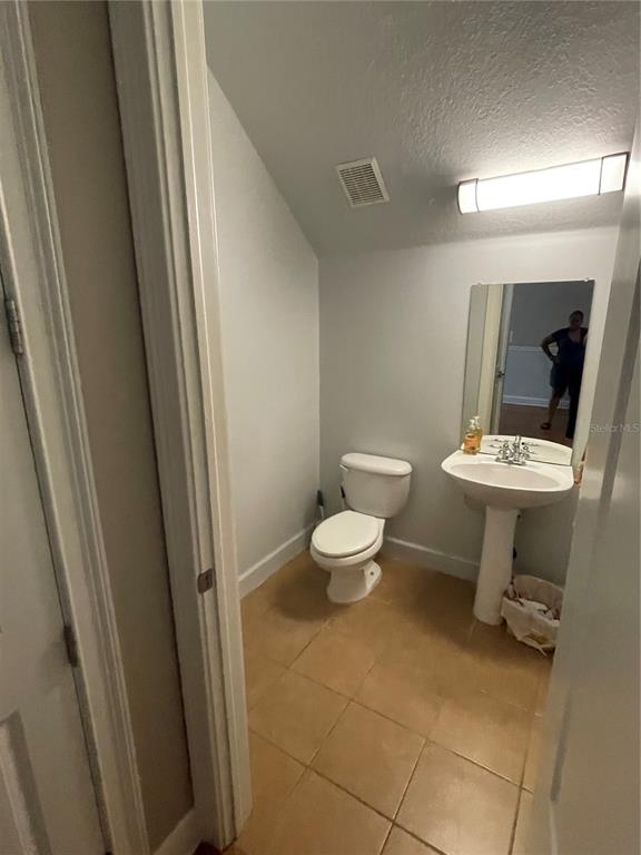 8405 Costa Bella Way Temple Terrace, FL 33637 - Photo 5 of 6 a bathroom with a toilet sink and mirror