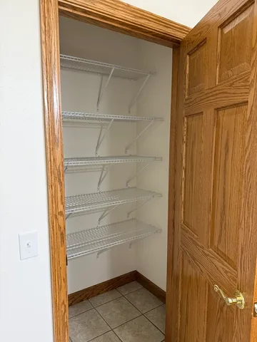 a view of walk in closet with empty racks