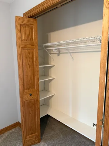 an empty room with closet area