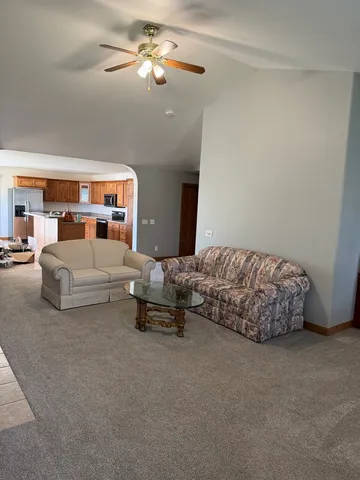 a spacious bedroom with a bed and a chandelier