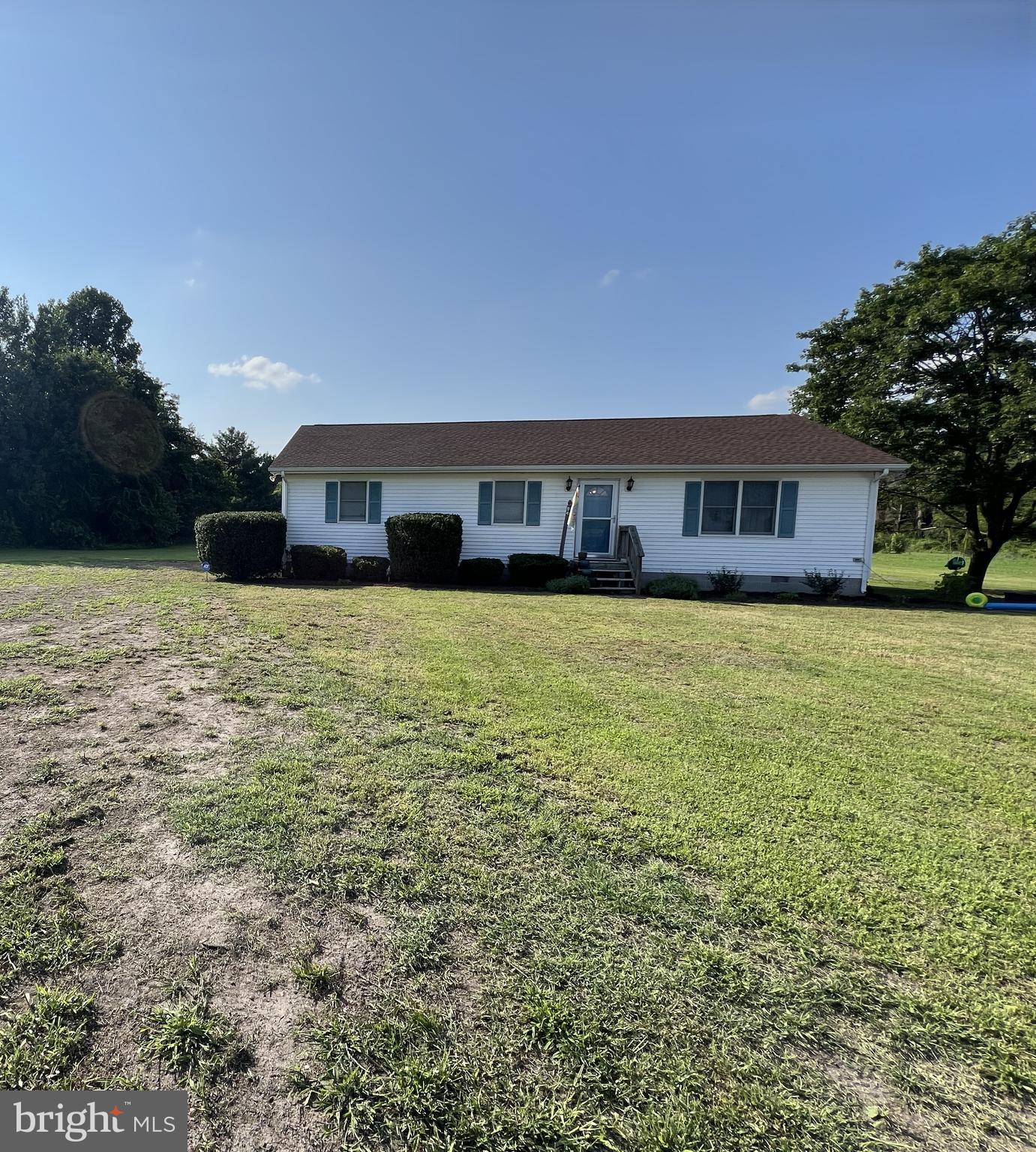 a view of a house with yard and sitting area