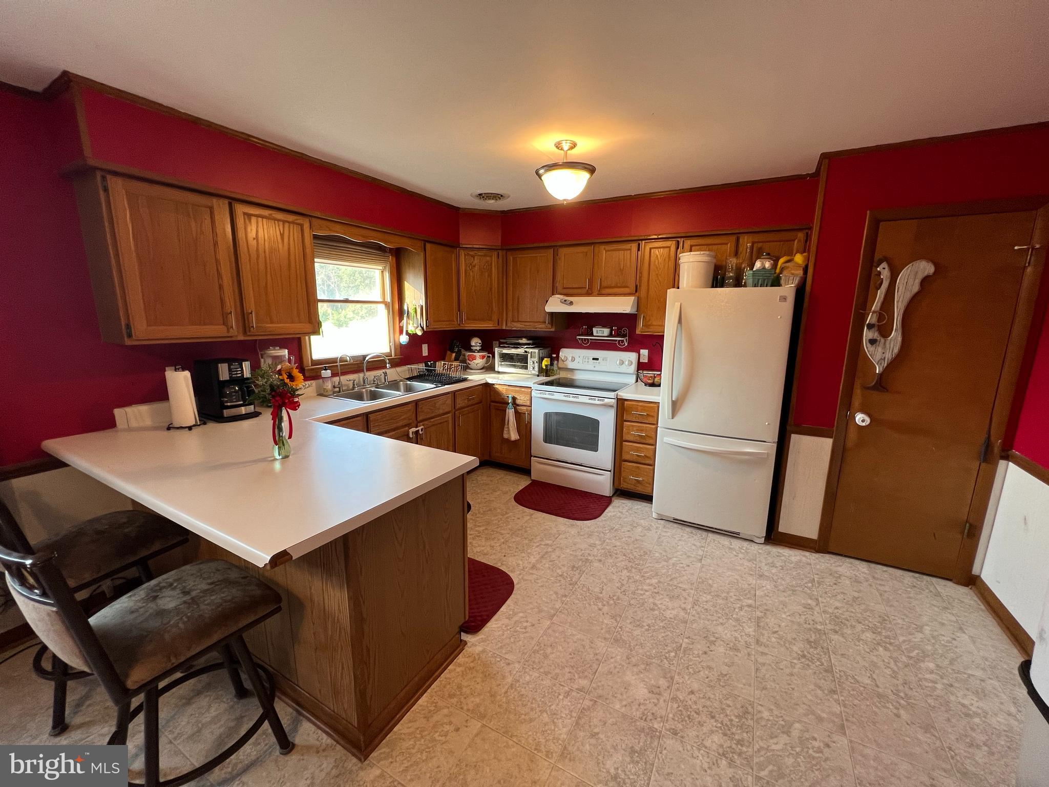 34788 Susan Beach Road Laurel, DE 19956 - Photo 17 of 36 a kitchen with refrigerator and window