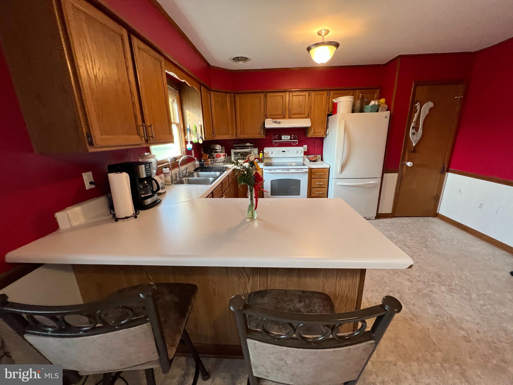34788 Susan Beach Road Laurel, DE 19956 - Photo 19 of 36 a kitchen with a sink a stove and chairs