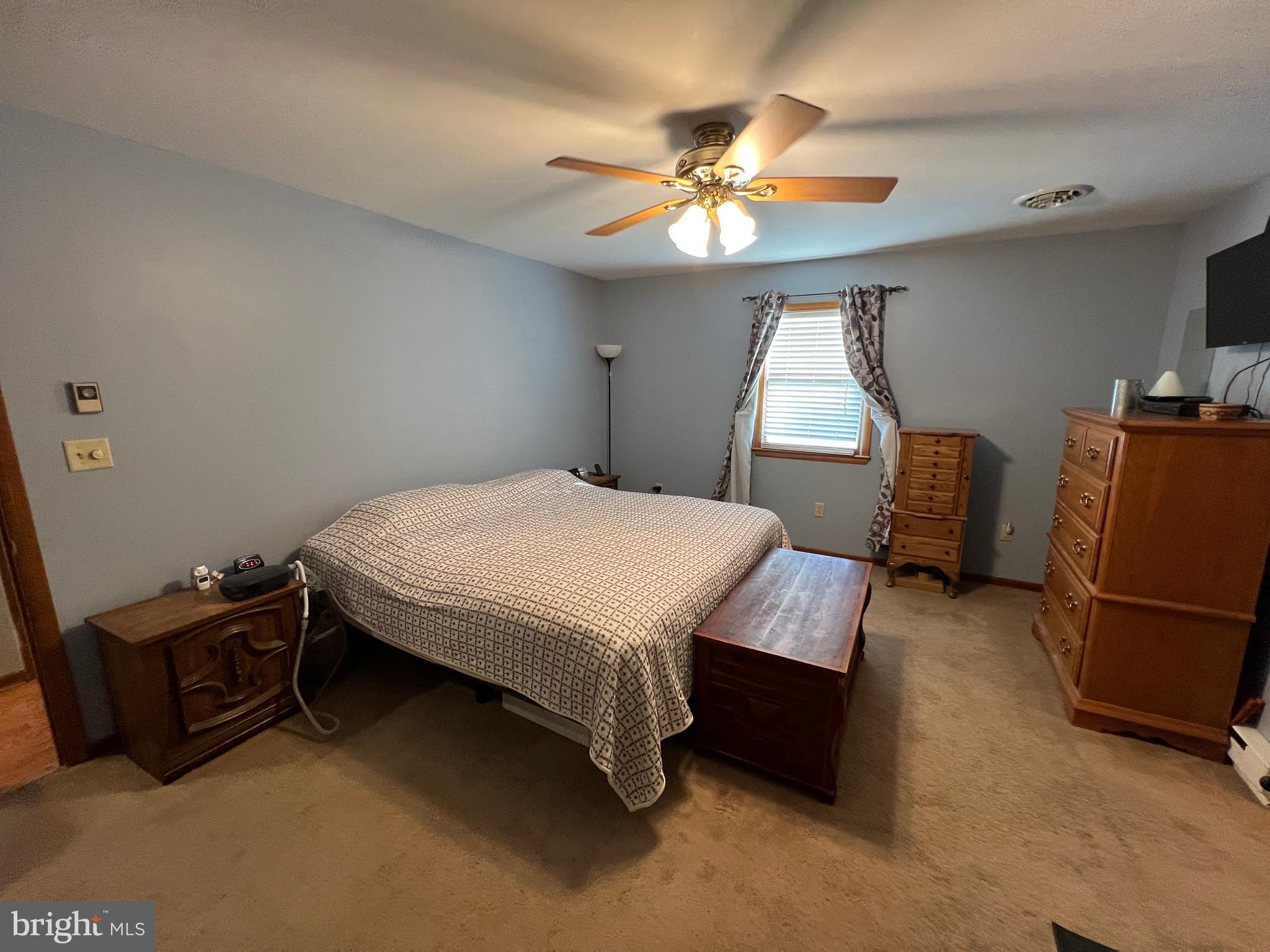34788 Susan Beach Road Laurel, DE 19956 - Photo 23 of 36 a bedroom with a bed and a chandelier