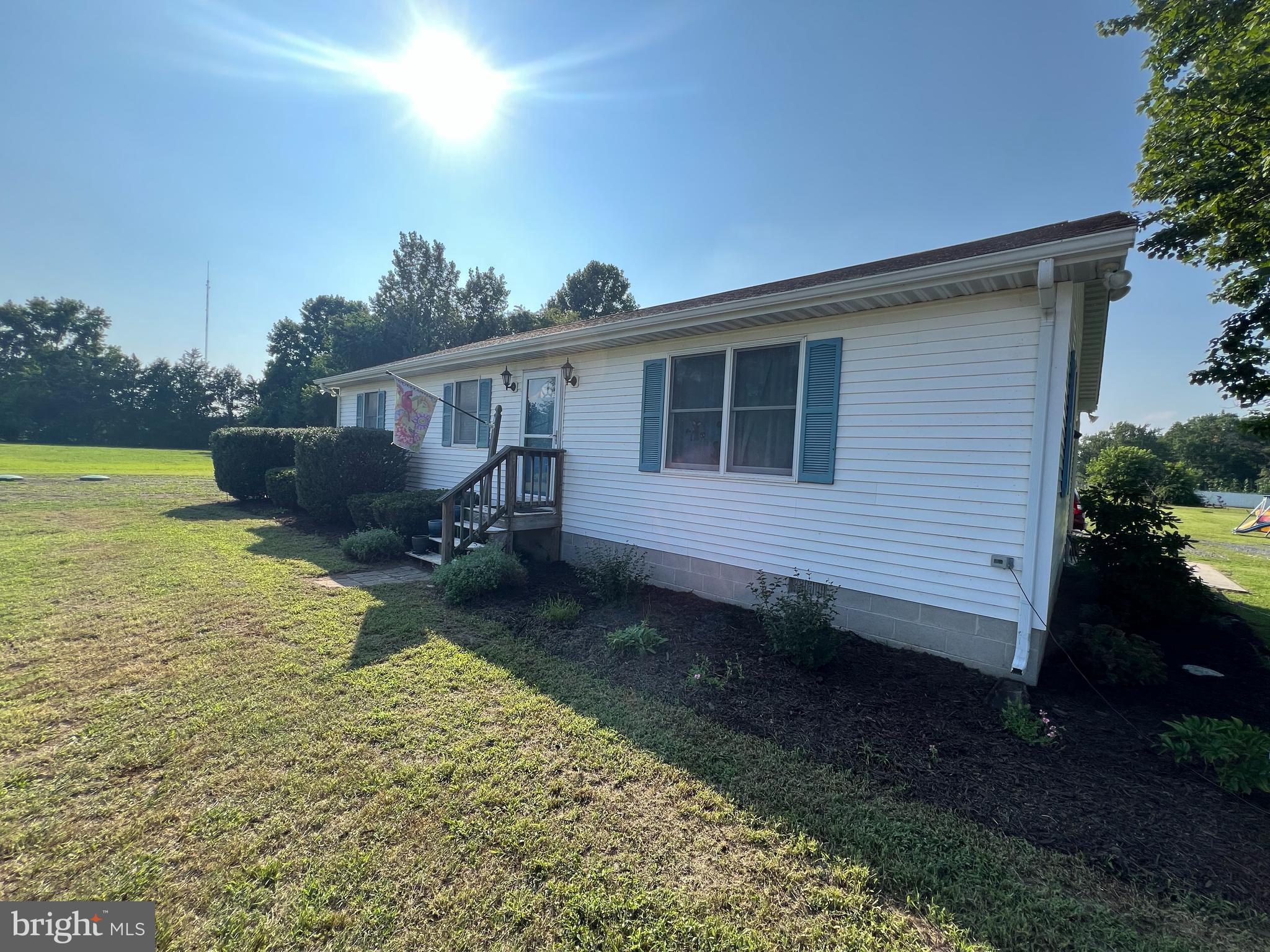 34788 Susan Beach Road Laurel, DE 19956 - Photo 3 of 36 a view of a backyard with chairs and floor to ceiling window