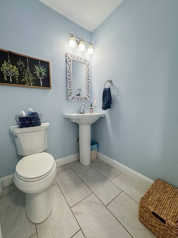 23 Ralph Street Chicopee, MA 01020 - Photo 14 of 42 a bathroom with a toilet sink and mirror
