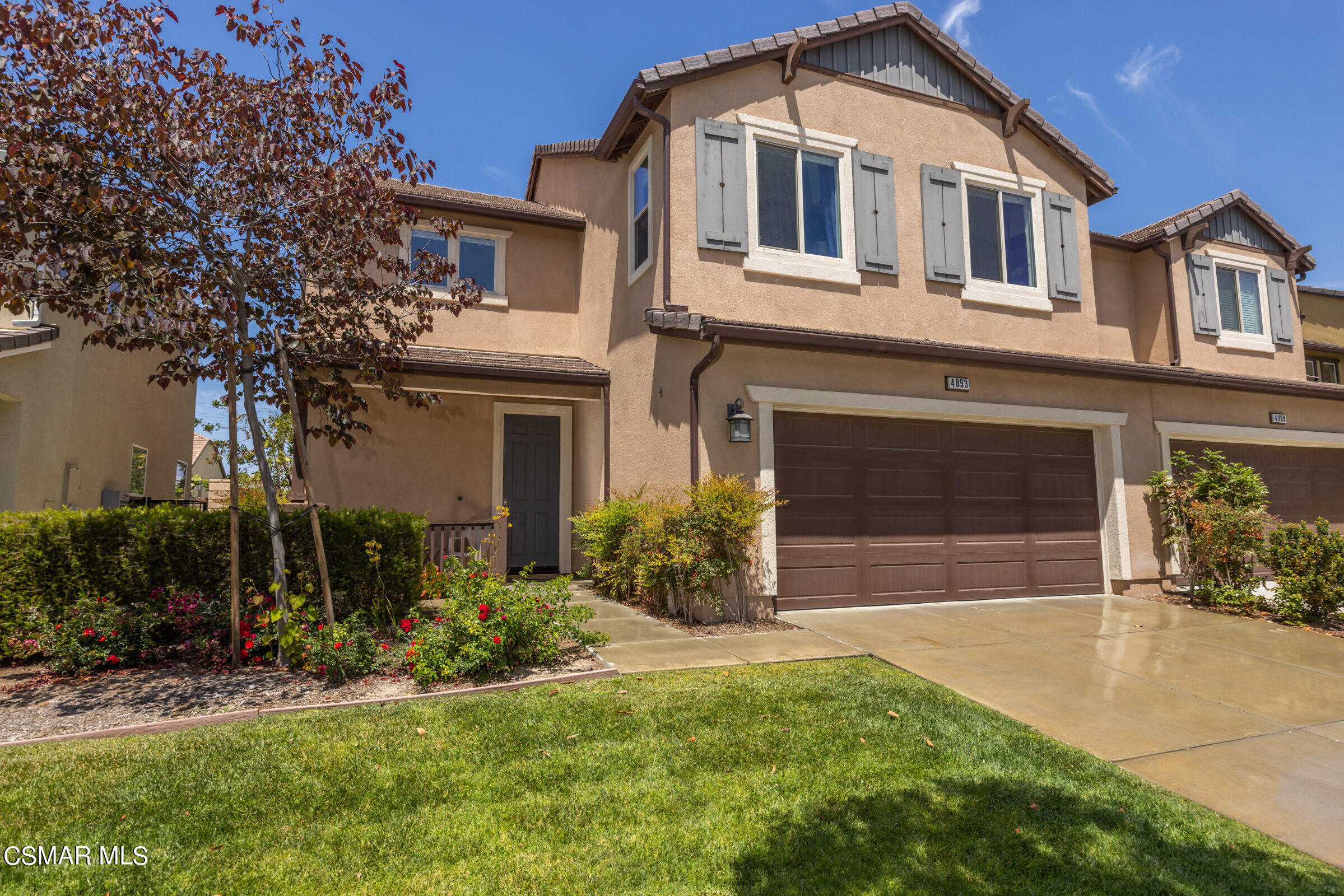 4893 Edenbridge Road Moorpark, CA 93021 - Photo 1 of 31 a front view of a house with a yard and garage