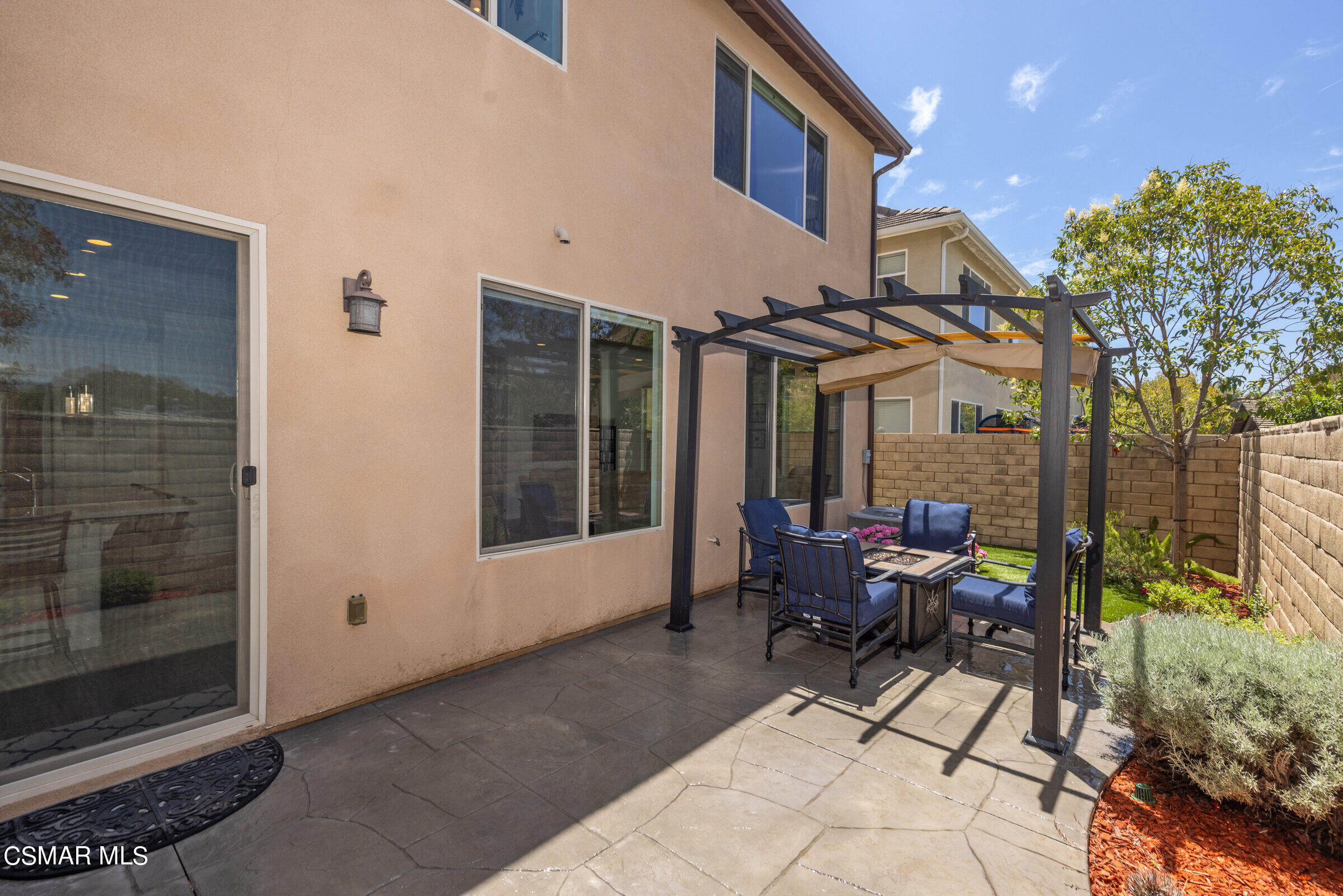 4893 Edenbridge Road Moorpark, CA 93021 - Photo 22 of 31 a view of a patio with table and chairs and floor to ceiling window and wooden fence