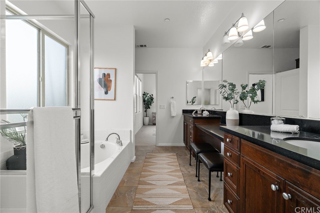 5429 Strand, Unit 101 Hawthorne, CA 90250 - Photo 19 of 39 a kitchen with stainless steel appliances granite countertop a refrigerator a sink dishwasher a dining table and chairs with wooden floor