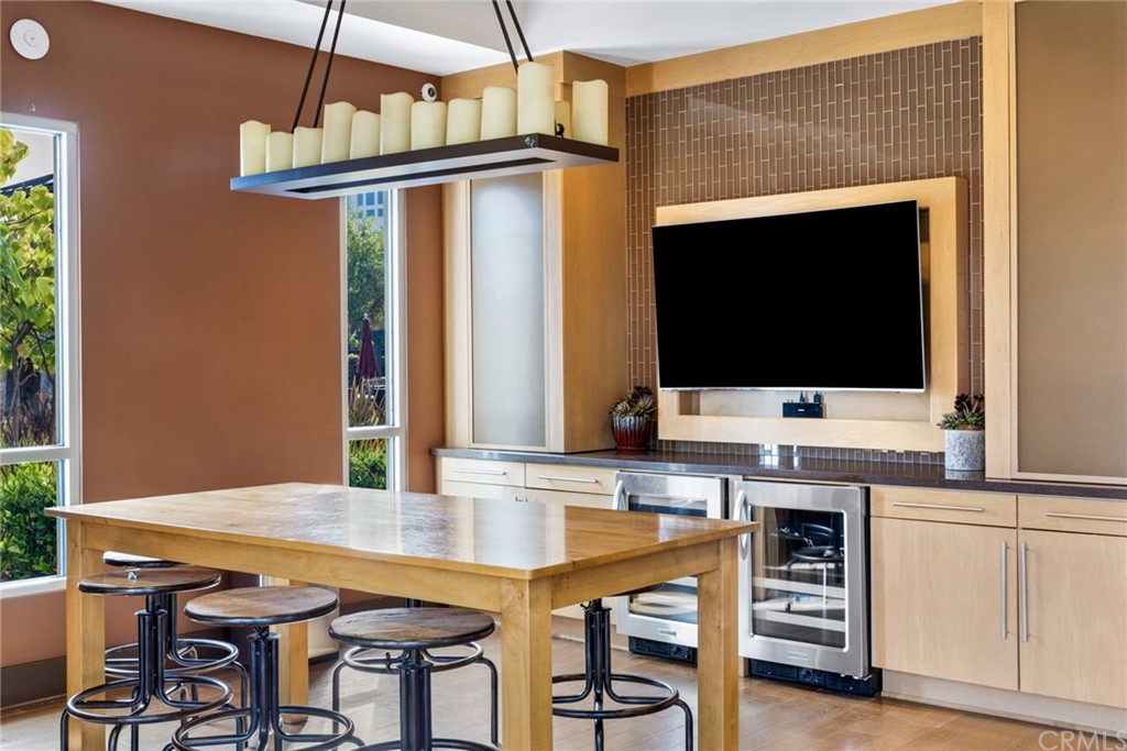 5429 Strand, Unit 101 Hawthorne, CA 90250 - Photo 37 of 39 a kitchen with a table chairs and a flat screen tv