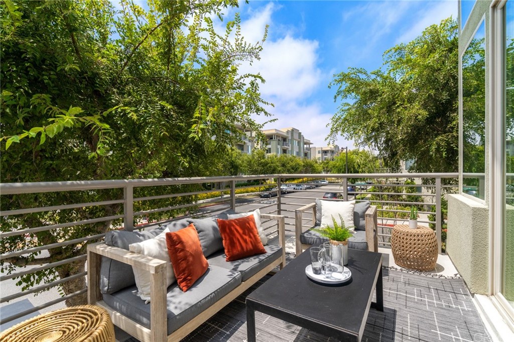 5429 Strand, Unit 101 Hawthorne, CA 90250 - Photo 4 of 39 a view of deck that has couches and potted plants with sky view