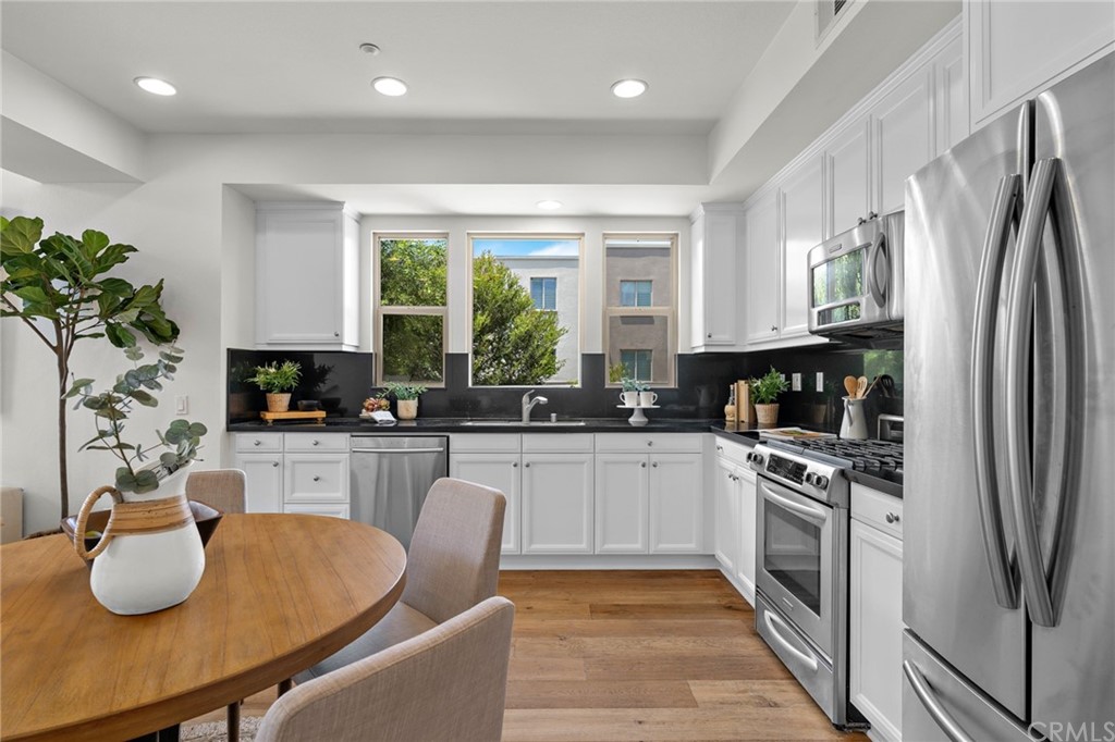 5429 Strand, Unit 101 Hawthorne, CA 90250 - Photo 7 of 39 a kitchen with granite countertop kitchen island stainless steel appliances a sink counter space and a window