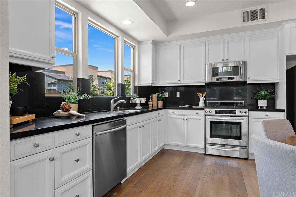 5429 Strand, Unit 101 Hawthorne, CA 90250 - Photo 8 of 39 a kitchen with appliances a sink and cabinets