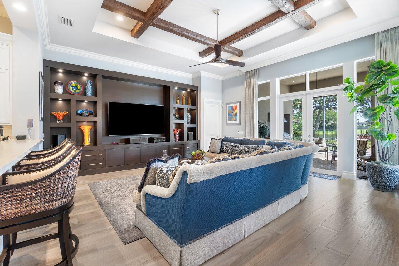 17526 Grand Este Way Boca Raton, FL 33496 - Photo 14 of 58 a living room with furniture a flat screen tv and a floor to ceiling window