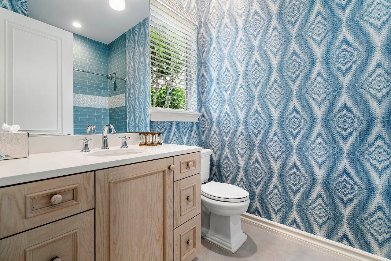 17526 Grand Este Way Boca Raton, FL 33496 - Photo 28 of 58 a bathroom with a toilet sink and mirror