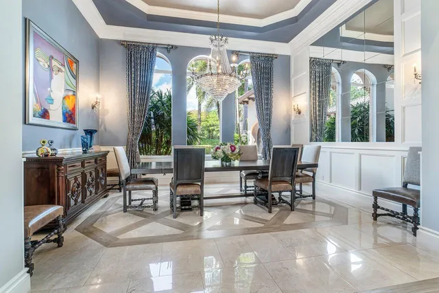 a living room with fireplace furniture and a chandelier