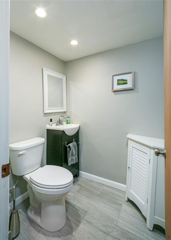 697 Filmore Road Pittsburgh, PA 15221 - Photo 41 of 42 a bathroom with a toilet a sink and mirror