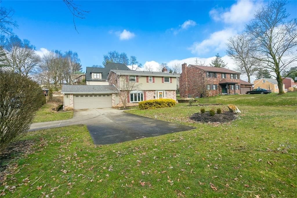697 Filmore Road Pittsburgh, PA 15221 - Photo 5 of 42 a view of a big house with a big yard and large trees