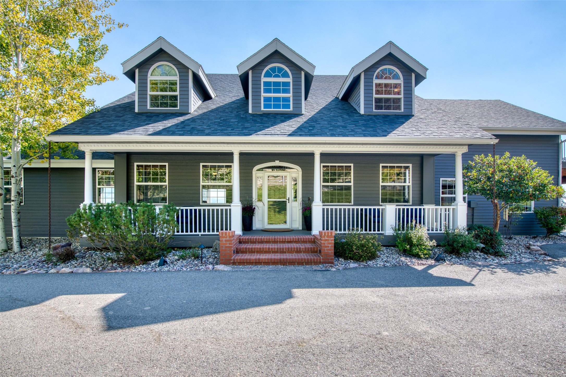 16374 Folsom Road Florence, MT 59833 - Photo 1 of 98 View of front of property with a shingled roof and a porch