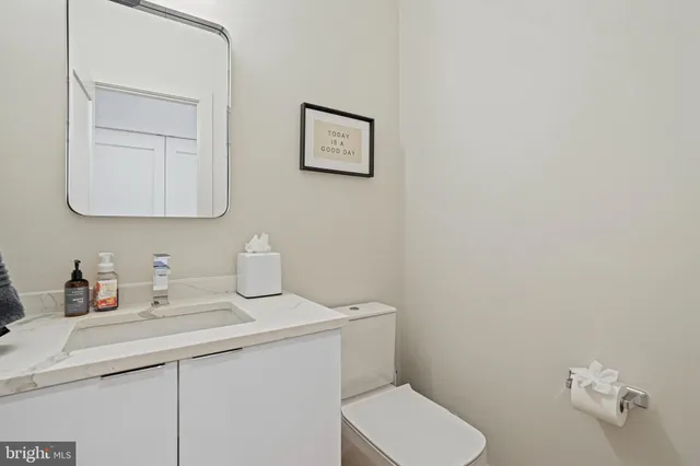 a bathroom with a toilet sink and mirror