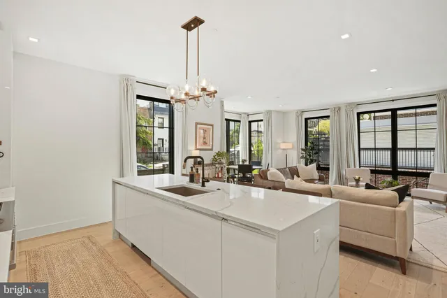 a view of living room with granite countertop furniture and a chandelier