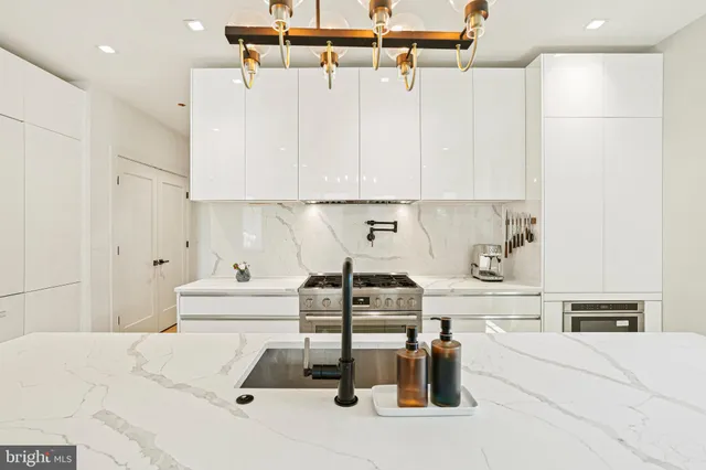 a kitchen with a refrigerator and white cabinets