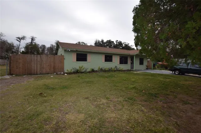 a view of backyard of house with green space