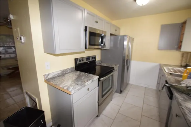 a kitchen with a sink appliances and cabinets