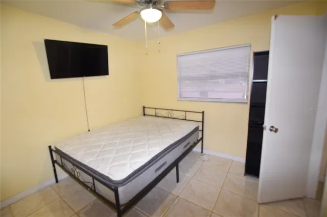 a living room with a flat screen tv and a wall painting