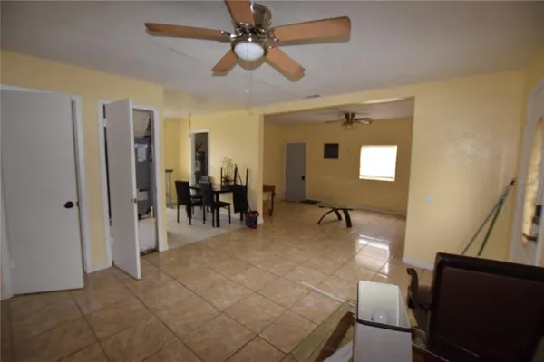 a view of a livingroom with furniture and a ceiling fan