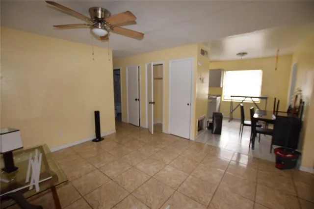 a view of a livingroom with furniture and a ceiling fan