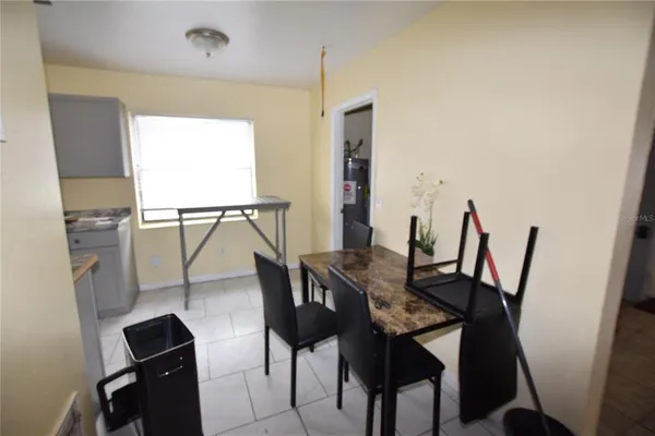 a view of a dining room with furniture and a window